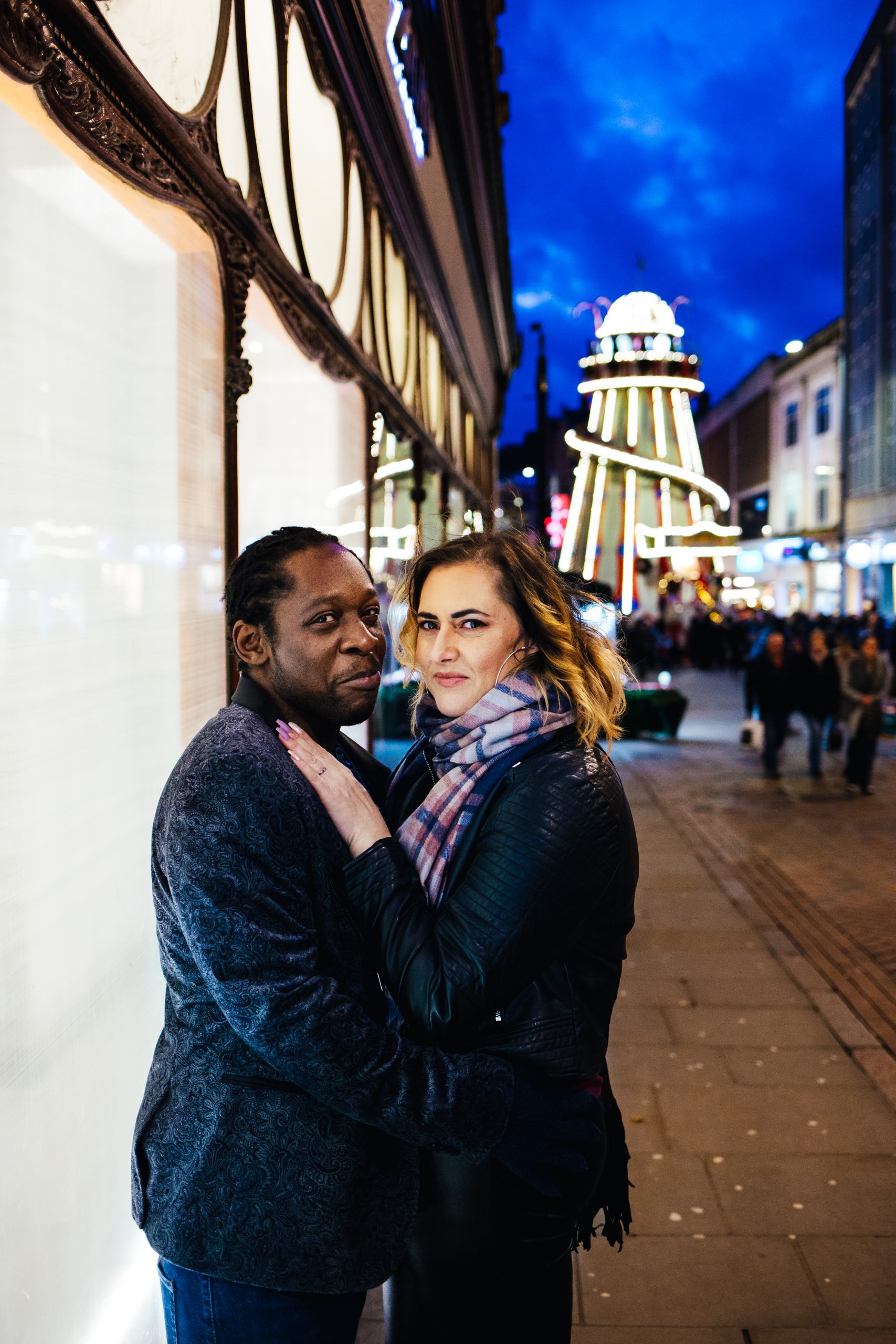 Fun Engagement Shoot2 Fun Engagement Shoot - Couple lit by shop window during engagement shoot with fairground in the background