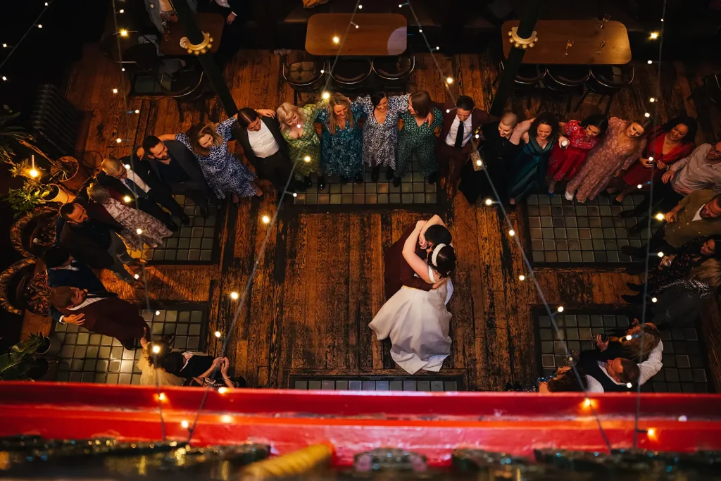 Couple Dancing taken from above surrounded by theire friends and family