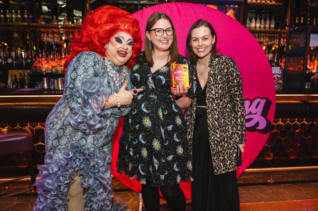 Kirsty winning her quirky wedding award she's stood between a lovely flamboyant drag queen and a member of the quirky family 