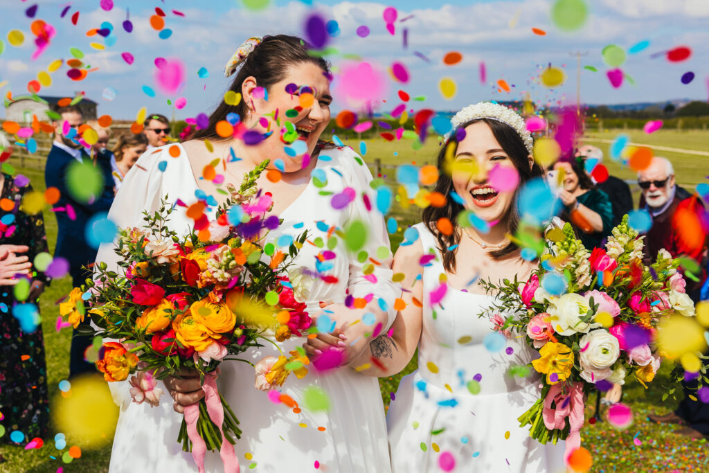 Couple during their rainbow confetti shot at the old cow shed in melton mowbray.