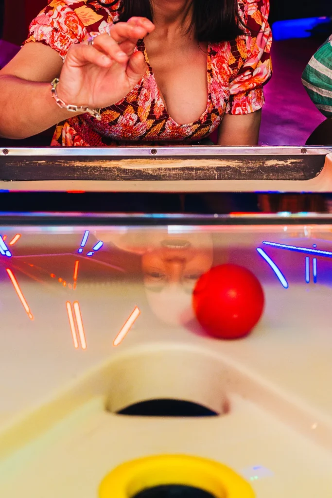 Wedding guest playing an arcade game during wedding reception