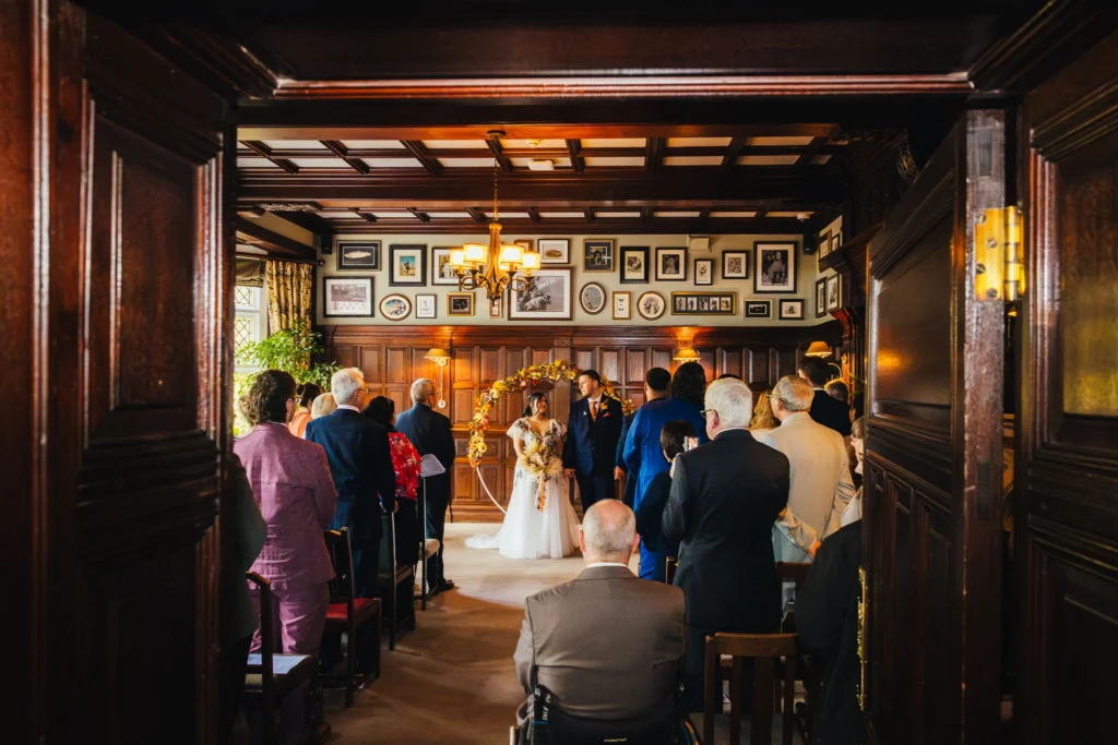Wide shot of bride and groom as they're about to walk back up the isle 