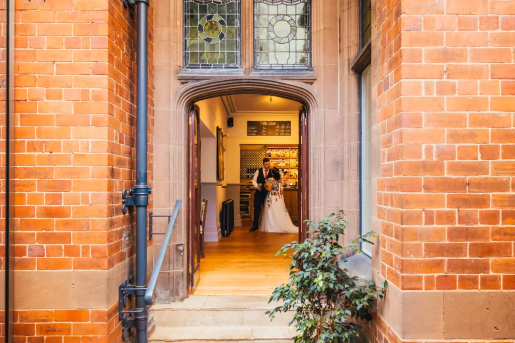 couple stood at bar waiting to enter the room for their meal
