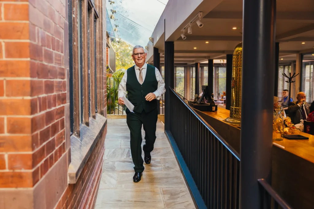 Dad walking to the front of the wedding breakfast to deliver his wedding speech