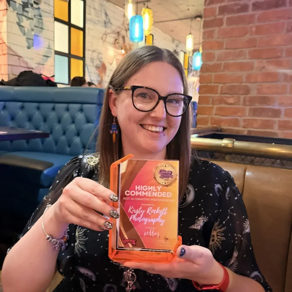 Kirsty Rockett smiling and holding her Highly Commended Best Alternative Photographer award