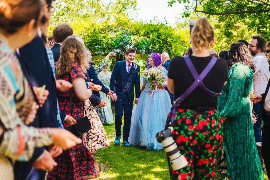 Kirsty photographing a couple among their guests after the ceremony