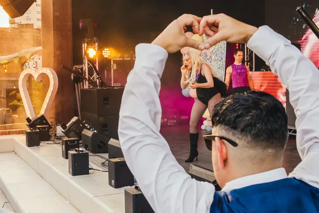 Guest making a heart with her hands for the band at Binks Yard