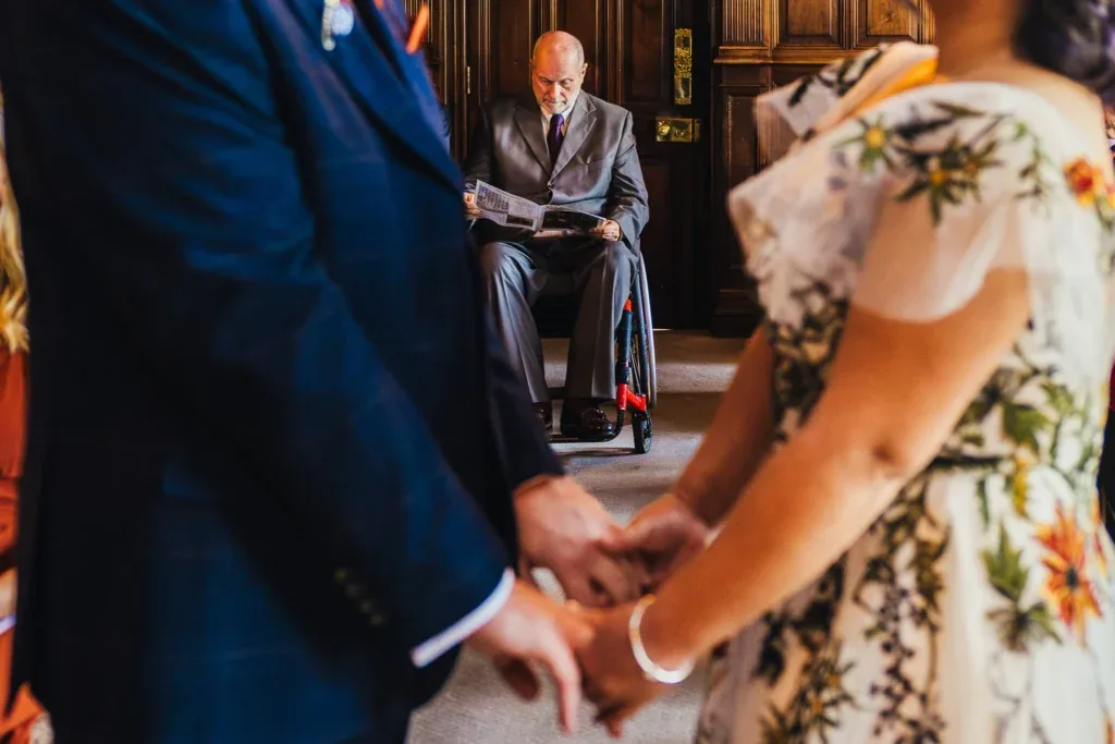 Couple holding hands during their ceremony at Chester Zoo