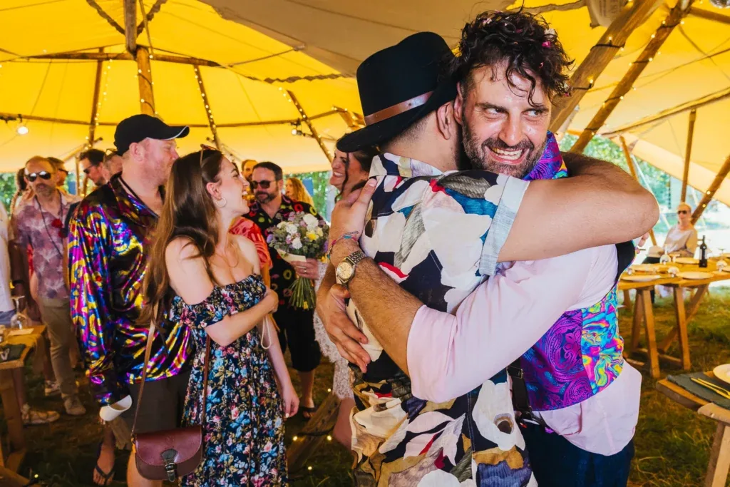 Guests hugging at a festival wedding