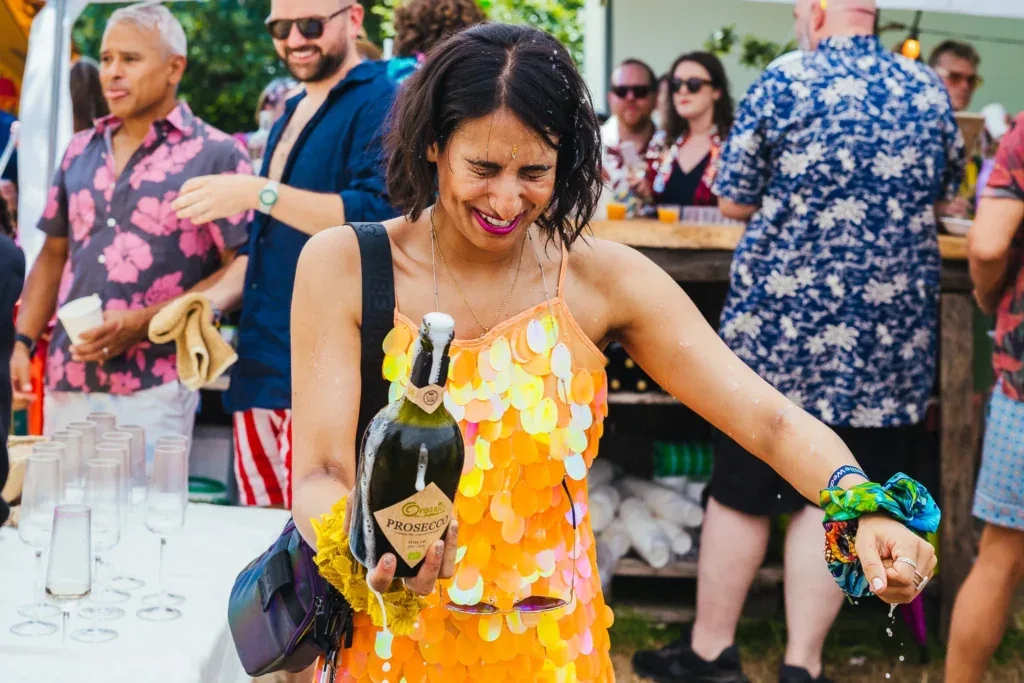 Guest laughing in a sequinned dress at a festival wedding