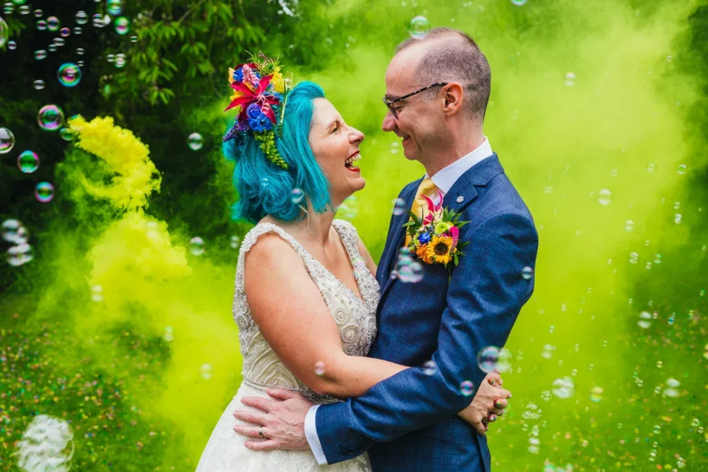 Couple laughing in smoke and bubbles