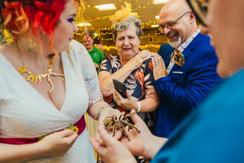 Bride holding a tarantula as her nan reacts