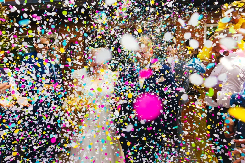 Couple in a confetti storm at a pub wedding